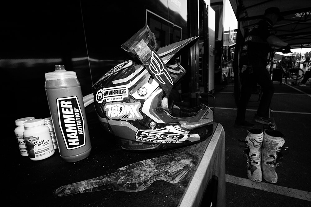 Racing helmet and gear in the pit